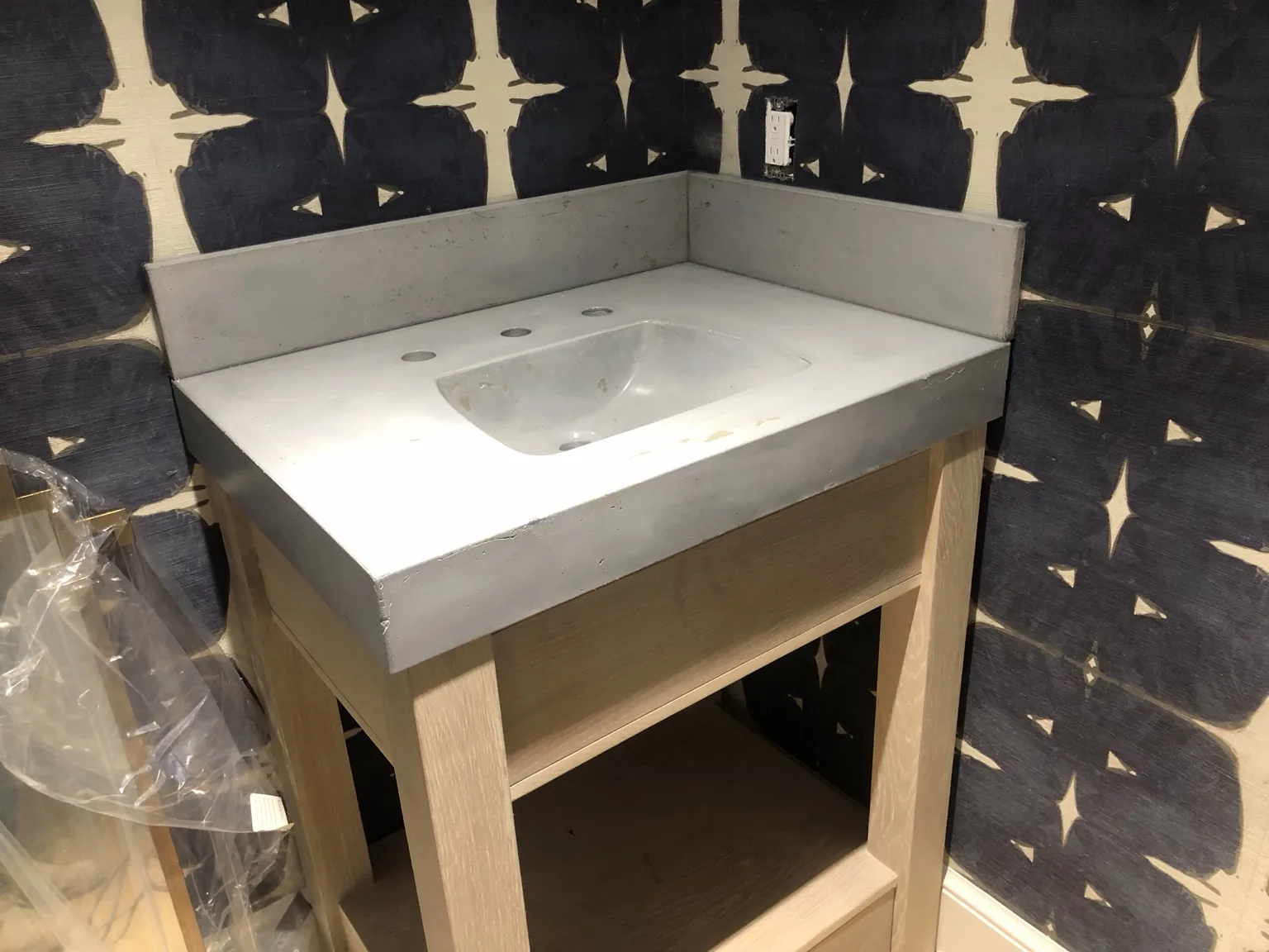 Custom concrete vanity with integrated sink